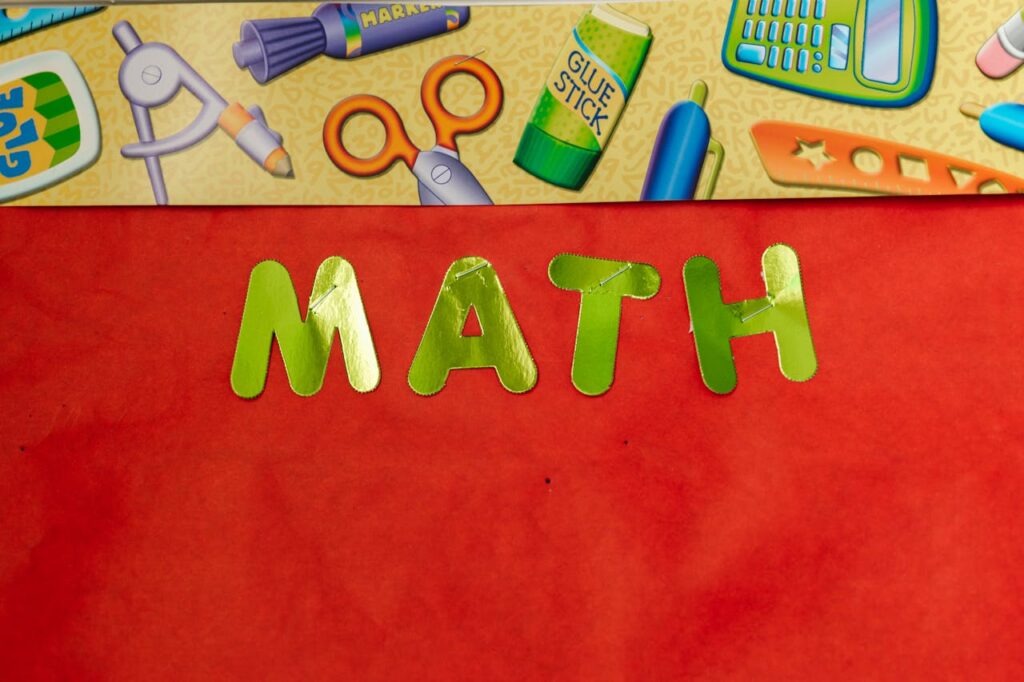 Bright educational banner featuring 'MATH' in green letters with school supplies illustration.